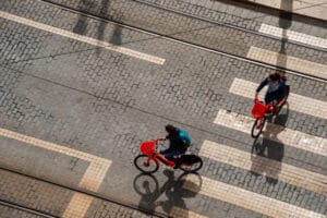 Top view of two people riding uber jump electric bikes